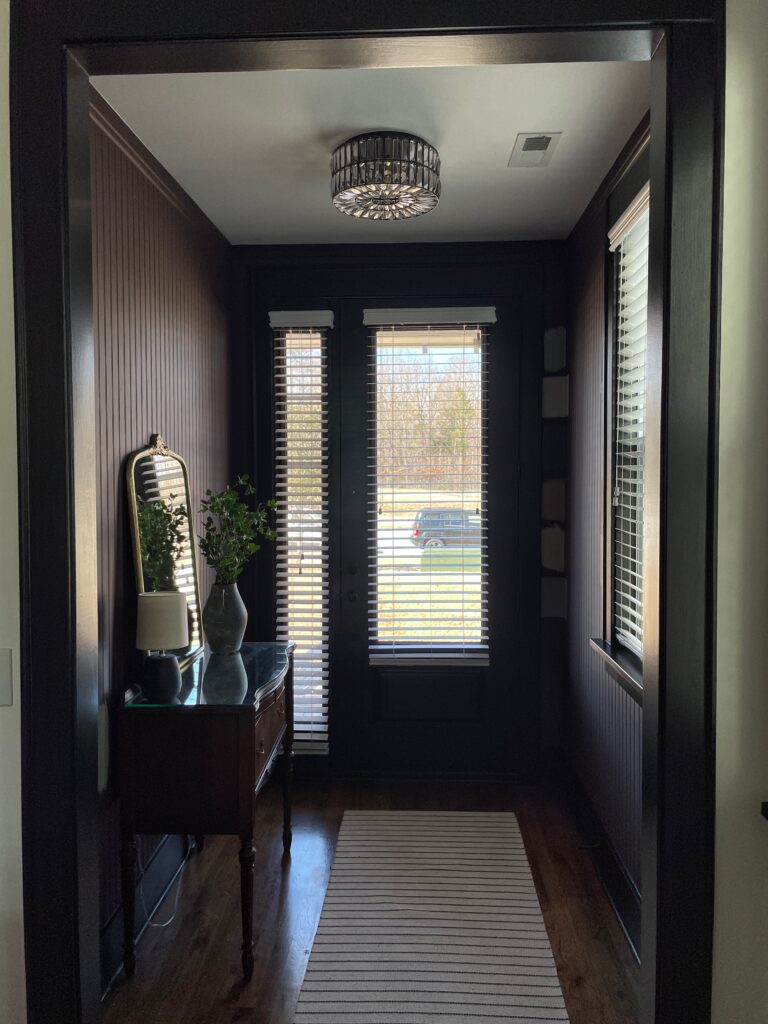 Elisha at Our Aesthetic Abode is showing her beadboard entryway makeover when it was purple. The color looks dark especially because the room has a lot of shadows.