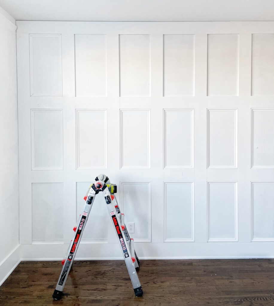 Elisha from Our Aesthetic Abode is showing her Recessed Wainscoting Accent Wall in progress. This picture shows that some of the panels have been framed out by trim, and some haven't. 