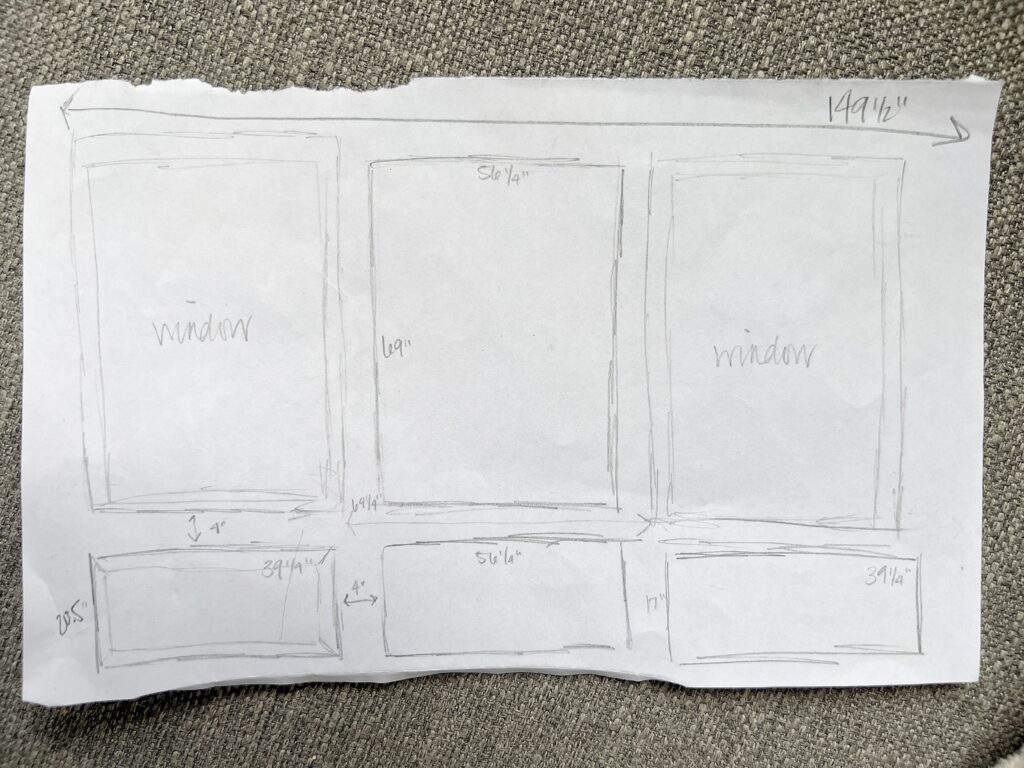 Elisha from Our Aesthetic Abode is showing her sketch of a wall with the layout for box molding and all of the measurements needed.