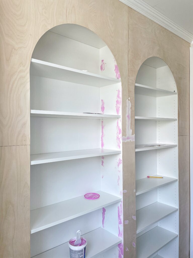 Ikea Billy bookcase built-ins with some of the holes filled with pink spackle