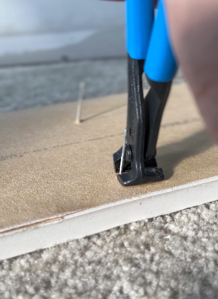 using end nippers to cut nails down after removing baseboards