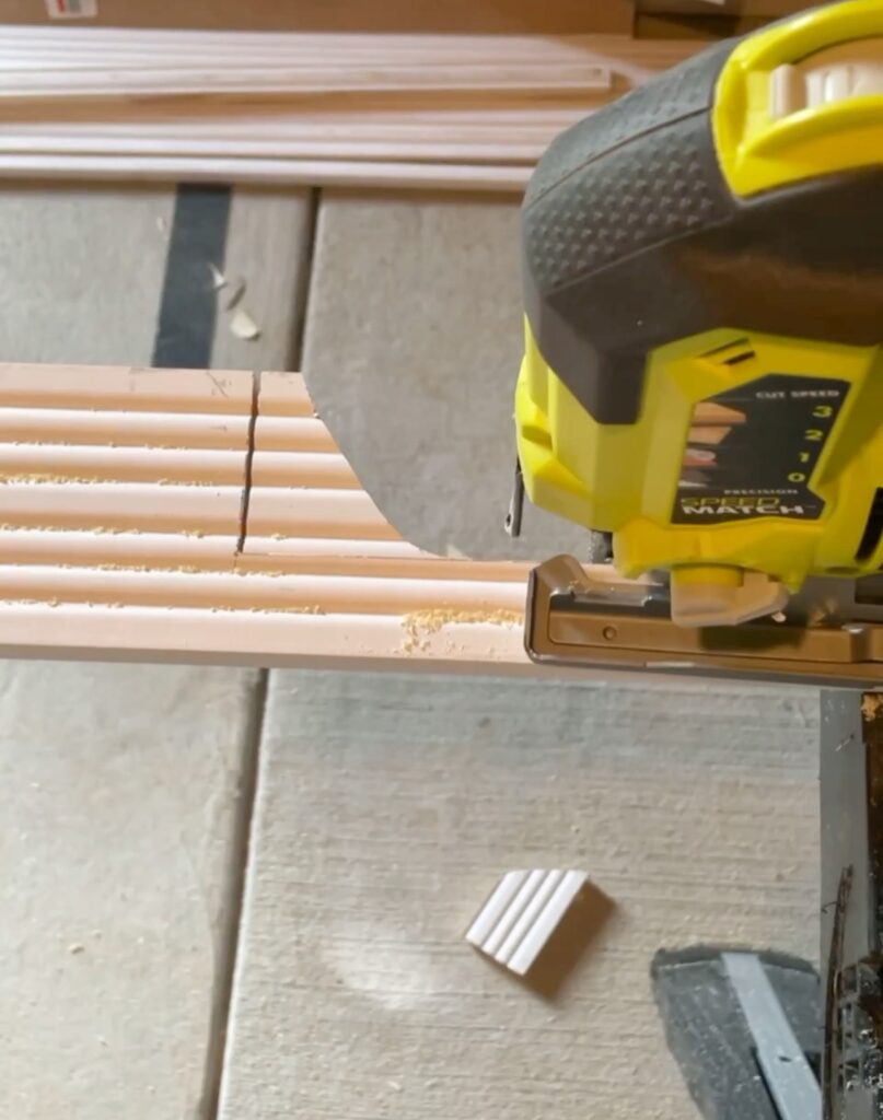 Using a jigsaw to cut into a fluted wood board for the outlet