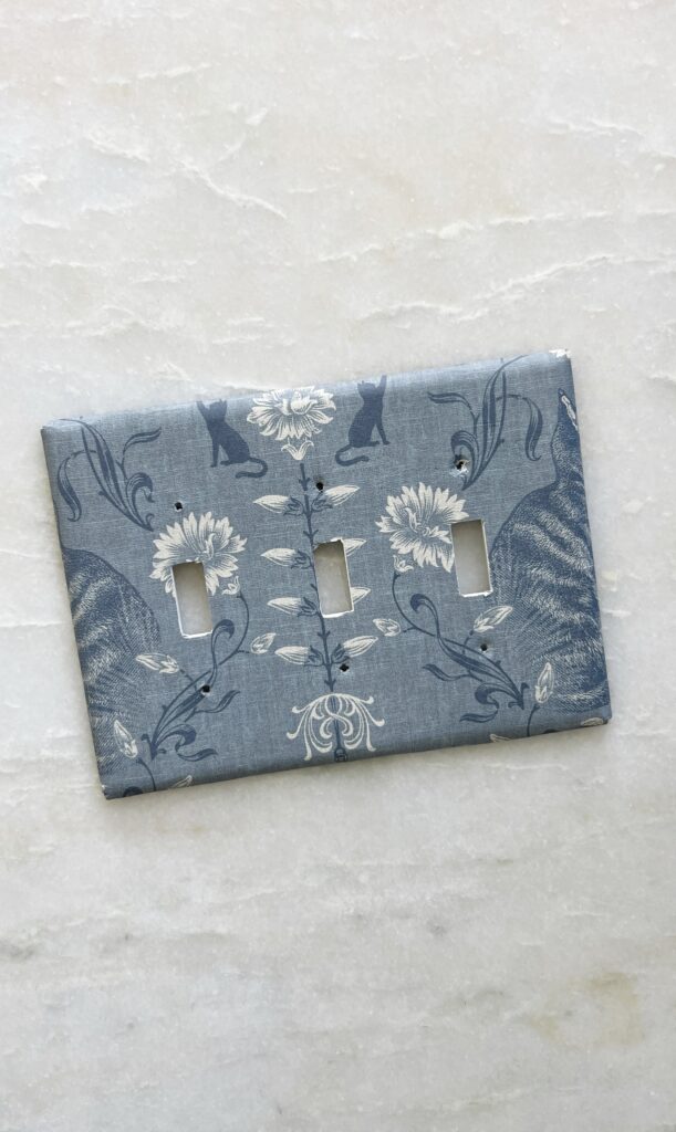 a wallpapered light switch cover