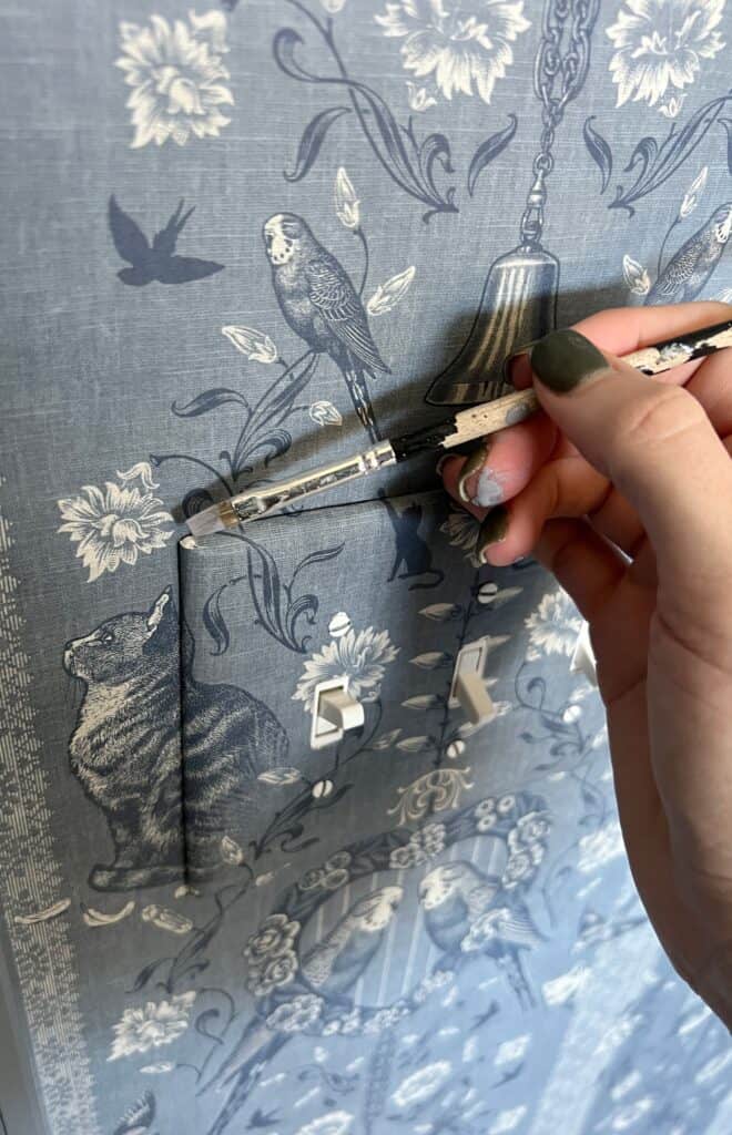 touching up wallpaper with paint