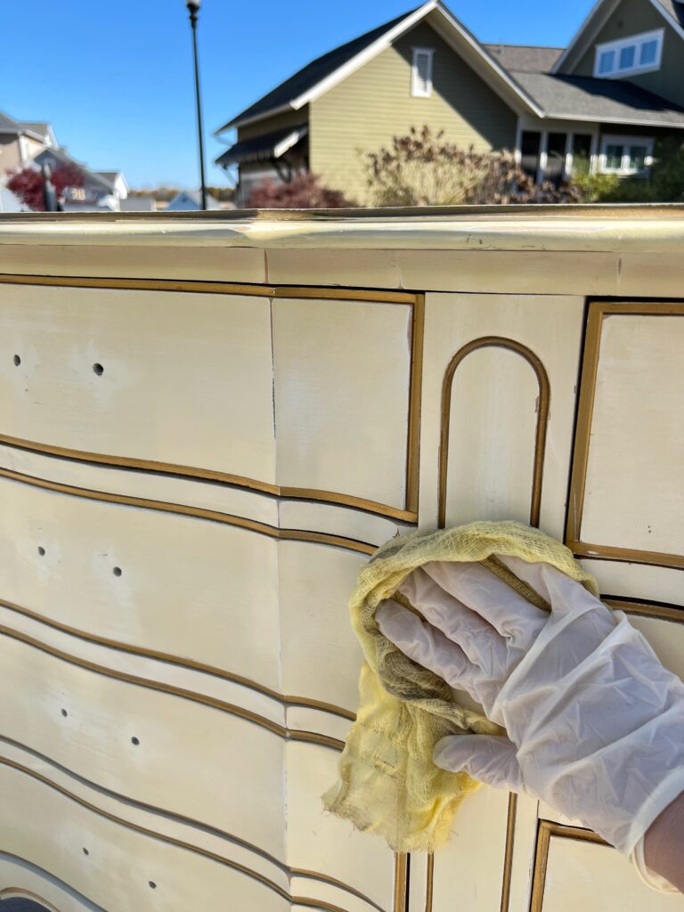 using a tack cloth before painting a French provincial dresser