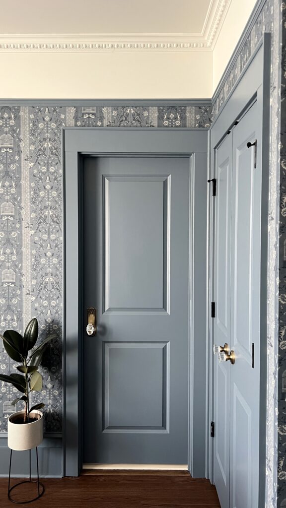 Doors painted Bachelor Blue by Benjamin Moore with antique brass hardware