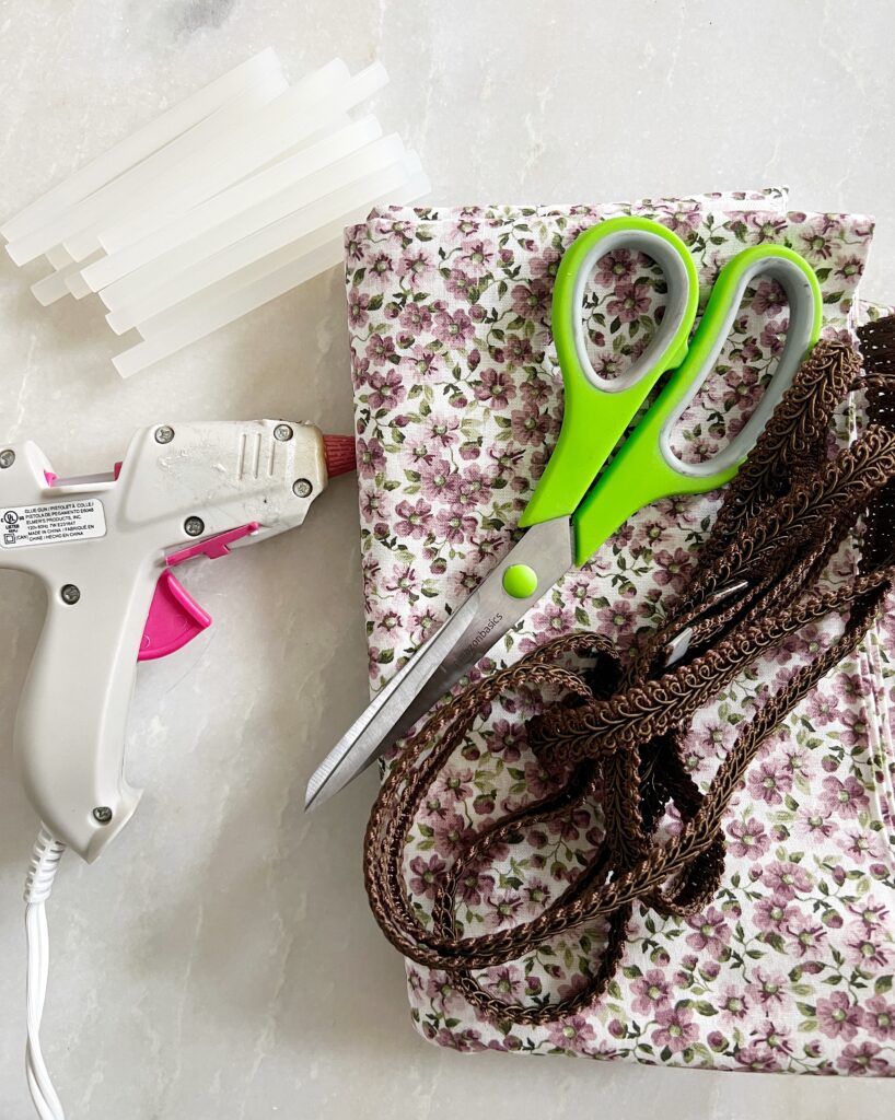 Materials for a DIY Lampshade; fabric, scissors, and hot glue