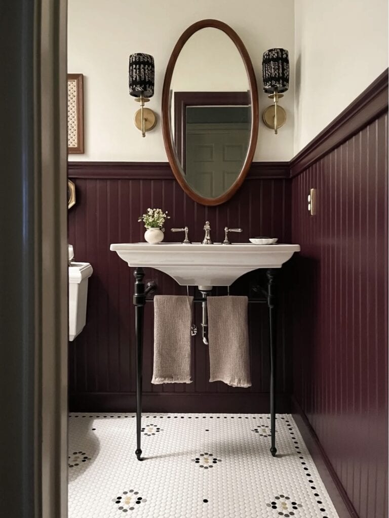 A beautiful bathroom with pleated fabric sconces