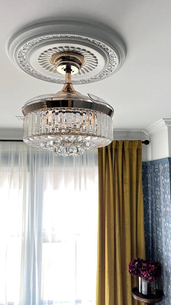 a crystal fandelier with a ceiling medallion