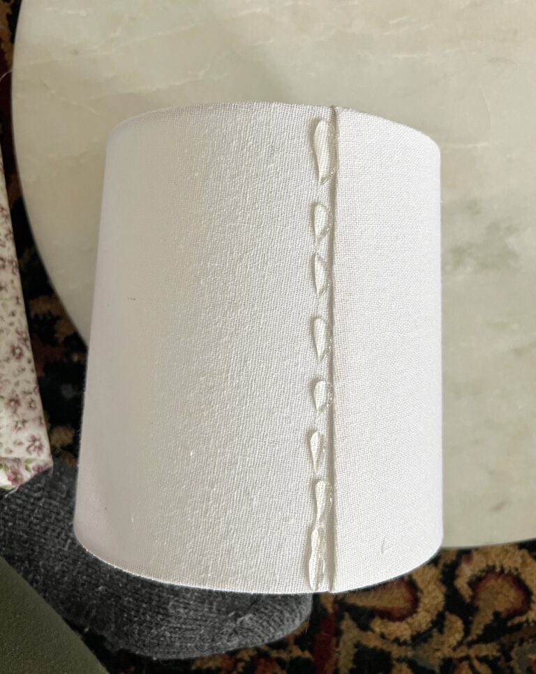 Using hot glue to attach fabric to a lampshade