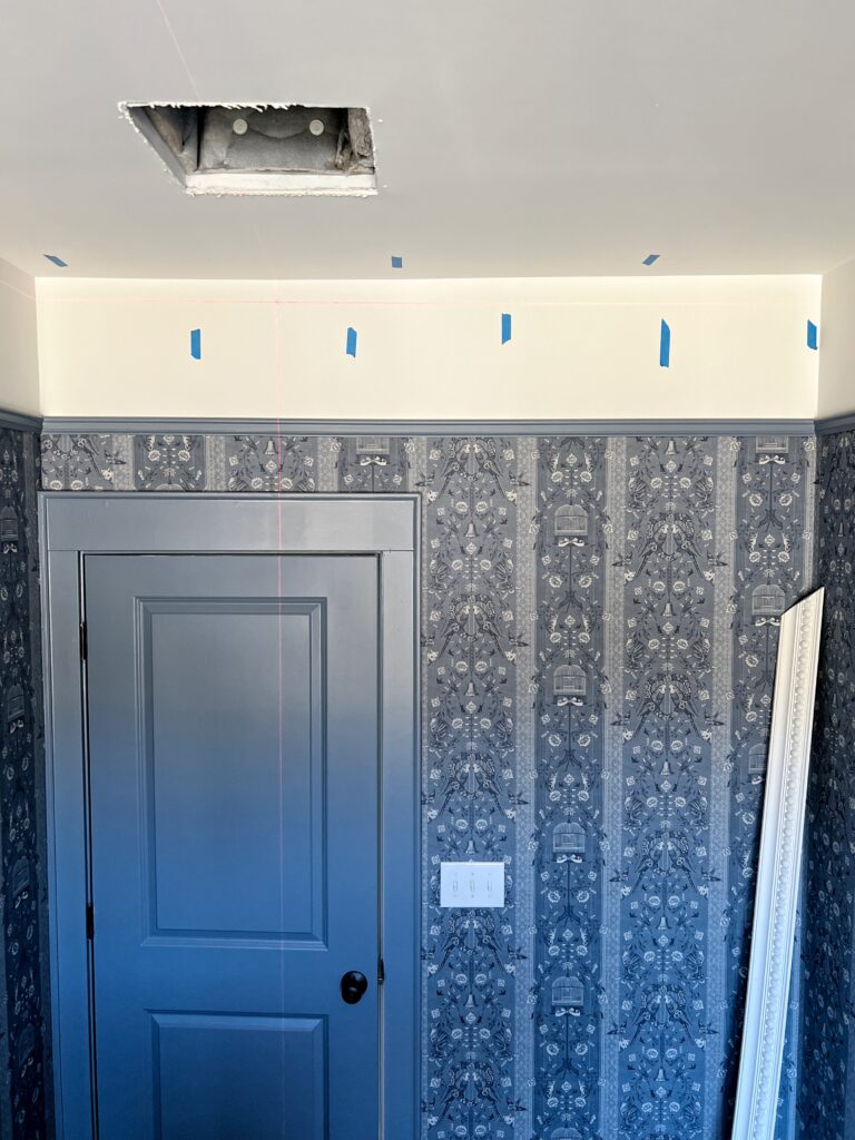 setting up a laser level for installing crown molding