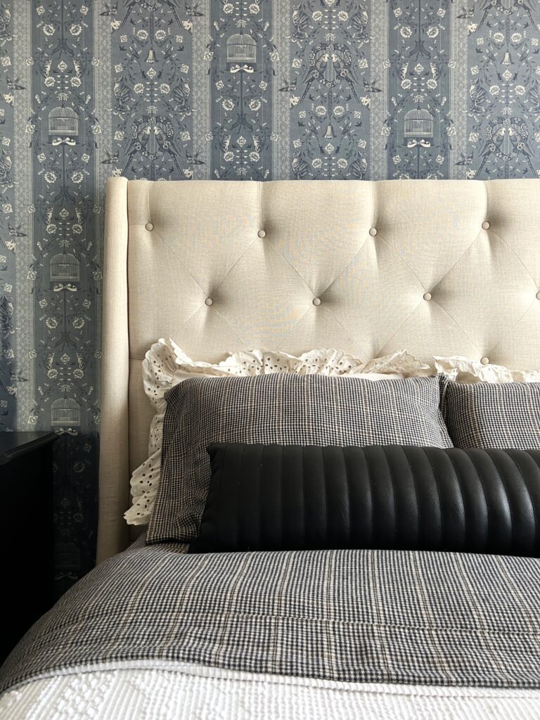 herringbone sheets, a black leather lumbar pillow, and ruffle shams for a vintage inspired bedroom