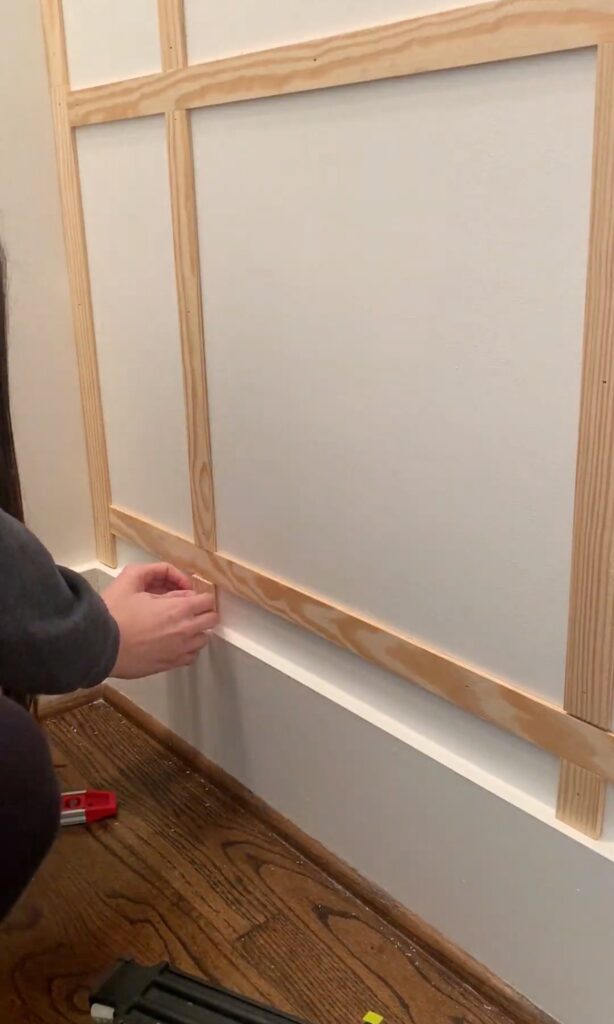 fitting the final piece for a DIY grid wall