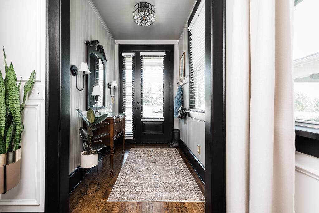 beadboard entryway with black trim and vintage aesthetic