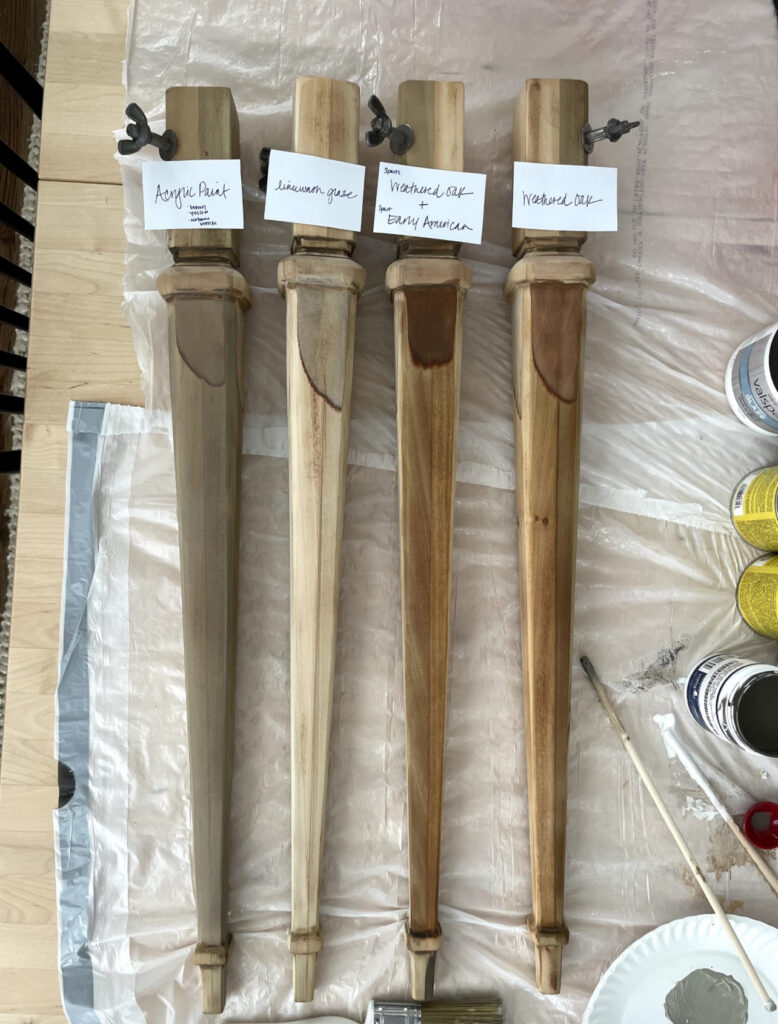 4 tapered vintage desk legs with 4 different finishing methods- each labeled on a piece of paper