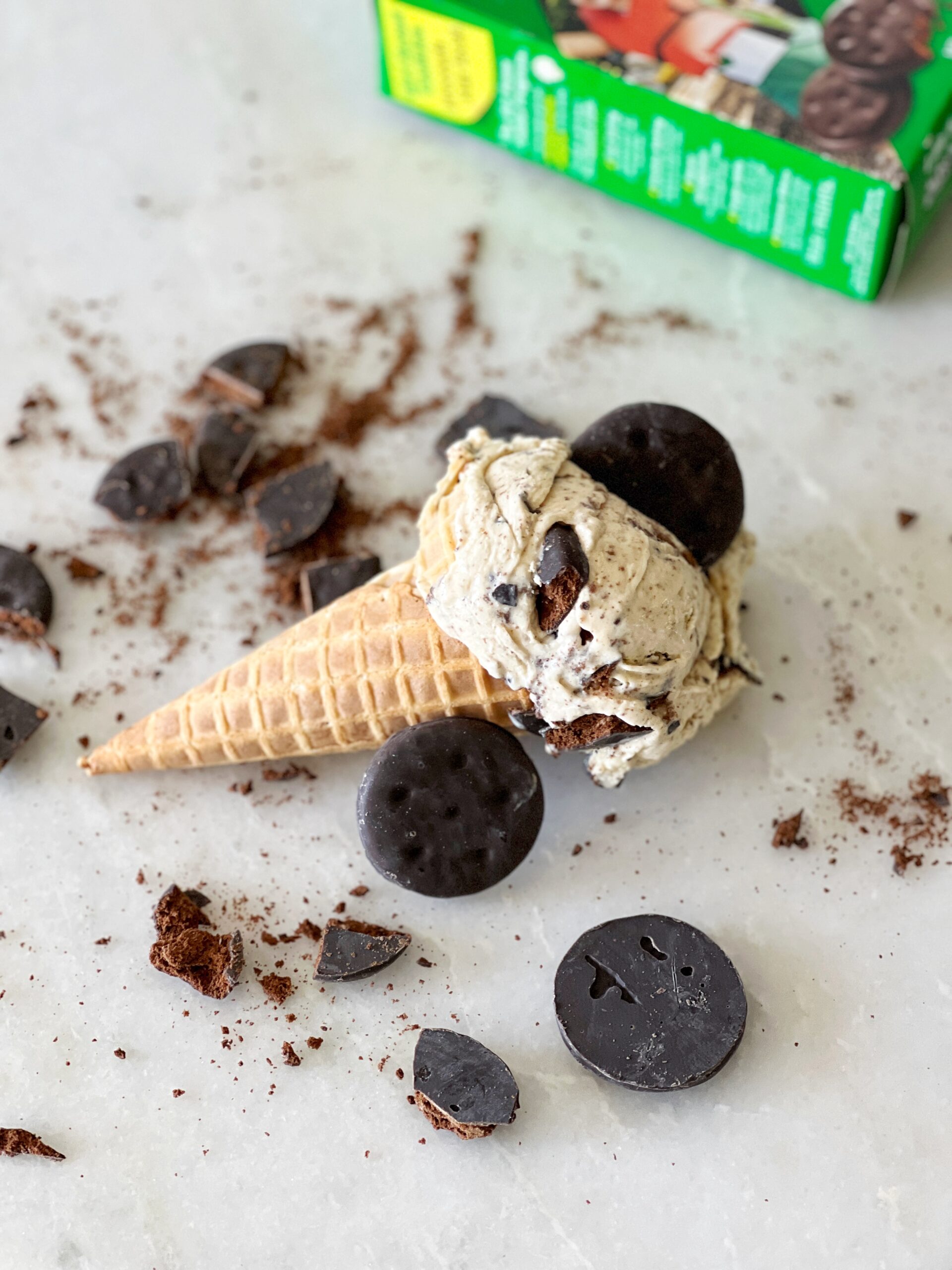 homemade thin mint cookie ice cream in a waffle cone