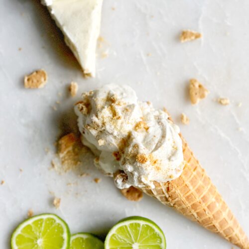 homemade coconut key lime pie ice cream in a waffle cone with graham cracker crumbles