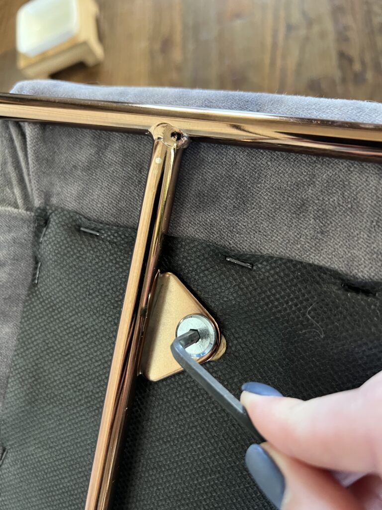 Using a hex wrench to take apart a chair for reupholstering