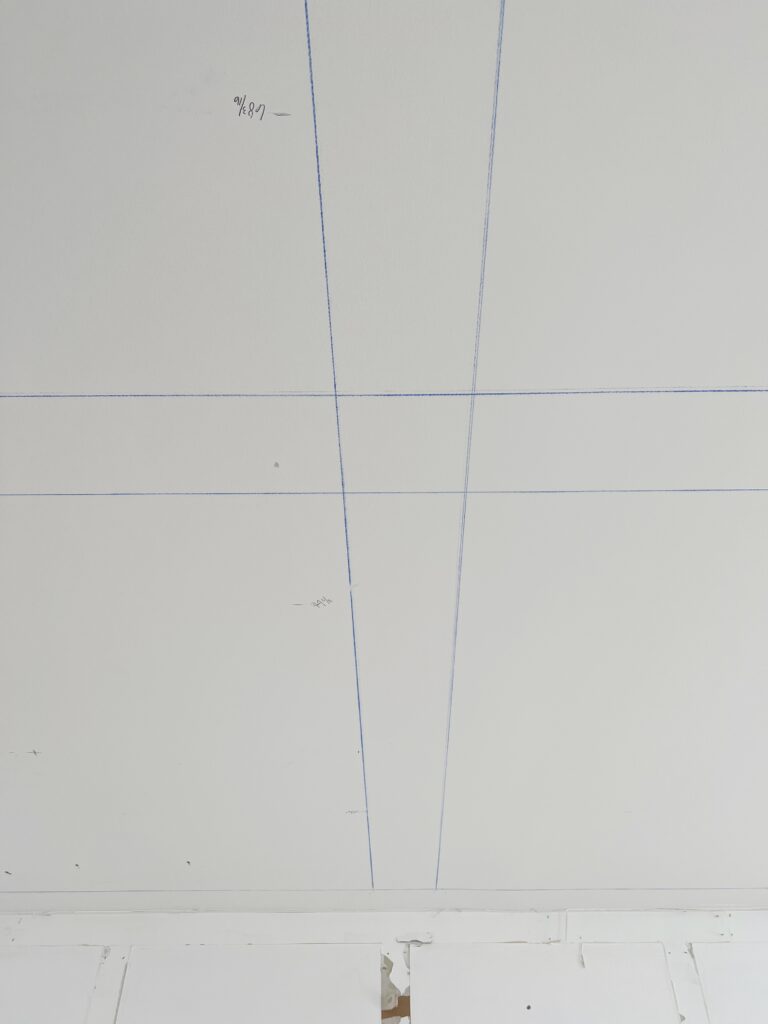 chalk lines on the ceiling marking the beam placement for a coffered ceiling