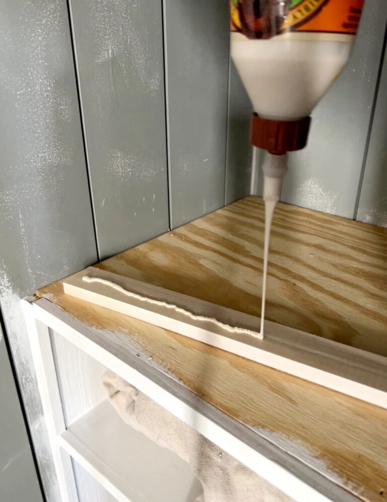 applying wood glue to the back of shaker peg rail