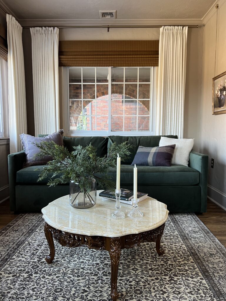 small sunroom with green velvet sofa