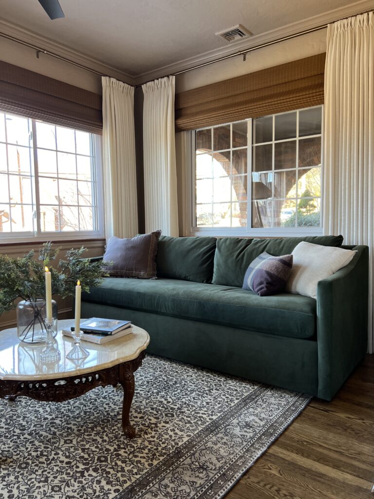 sunroom with green velvet sofa