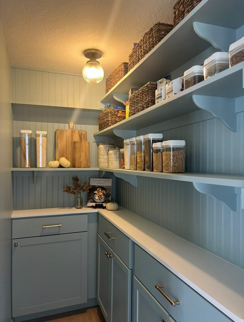 narrow walk in pantry with cabinets