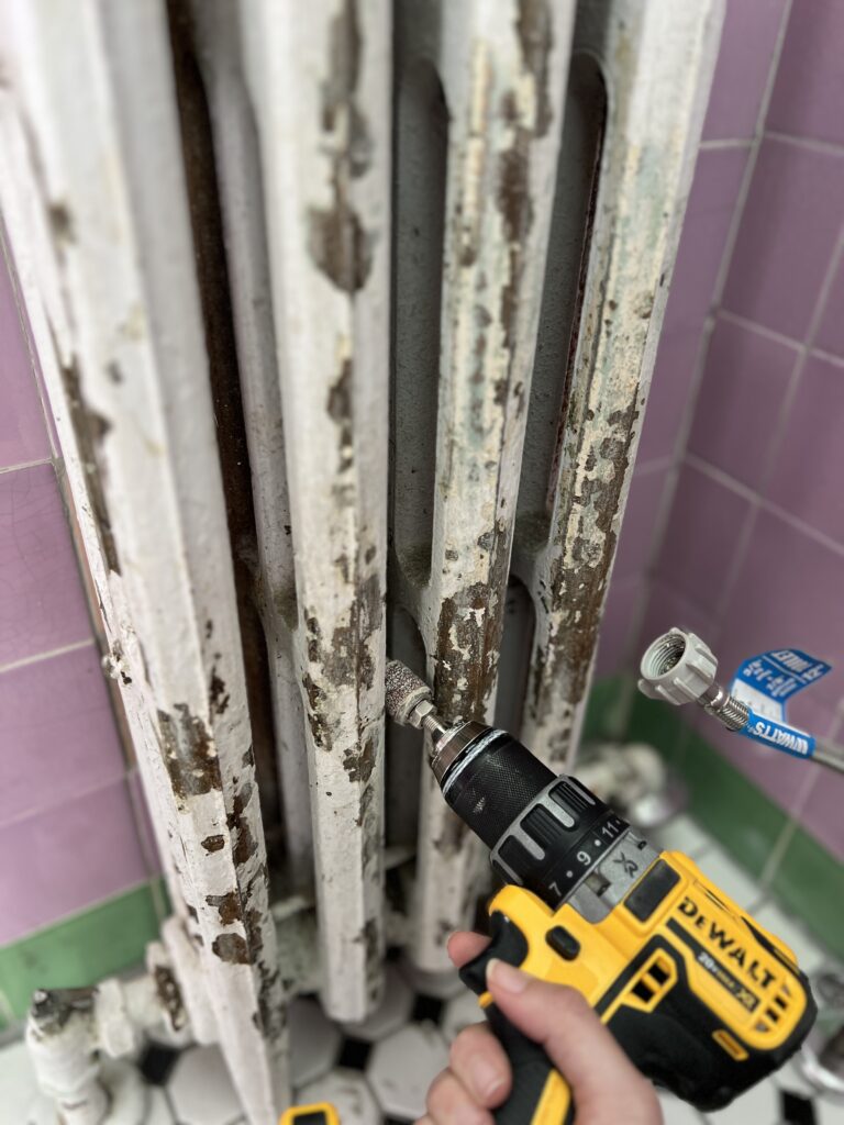 sanding a radiator before painting
