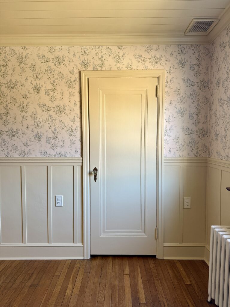 butter yellow nursery with floral wallpaper